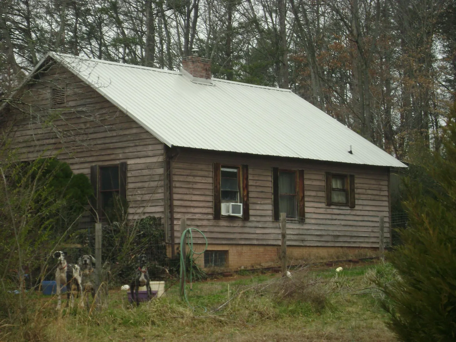 White metal roof on an old wood sided farmhouse, from a Metal Roof Installation job in Jefferson